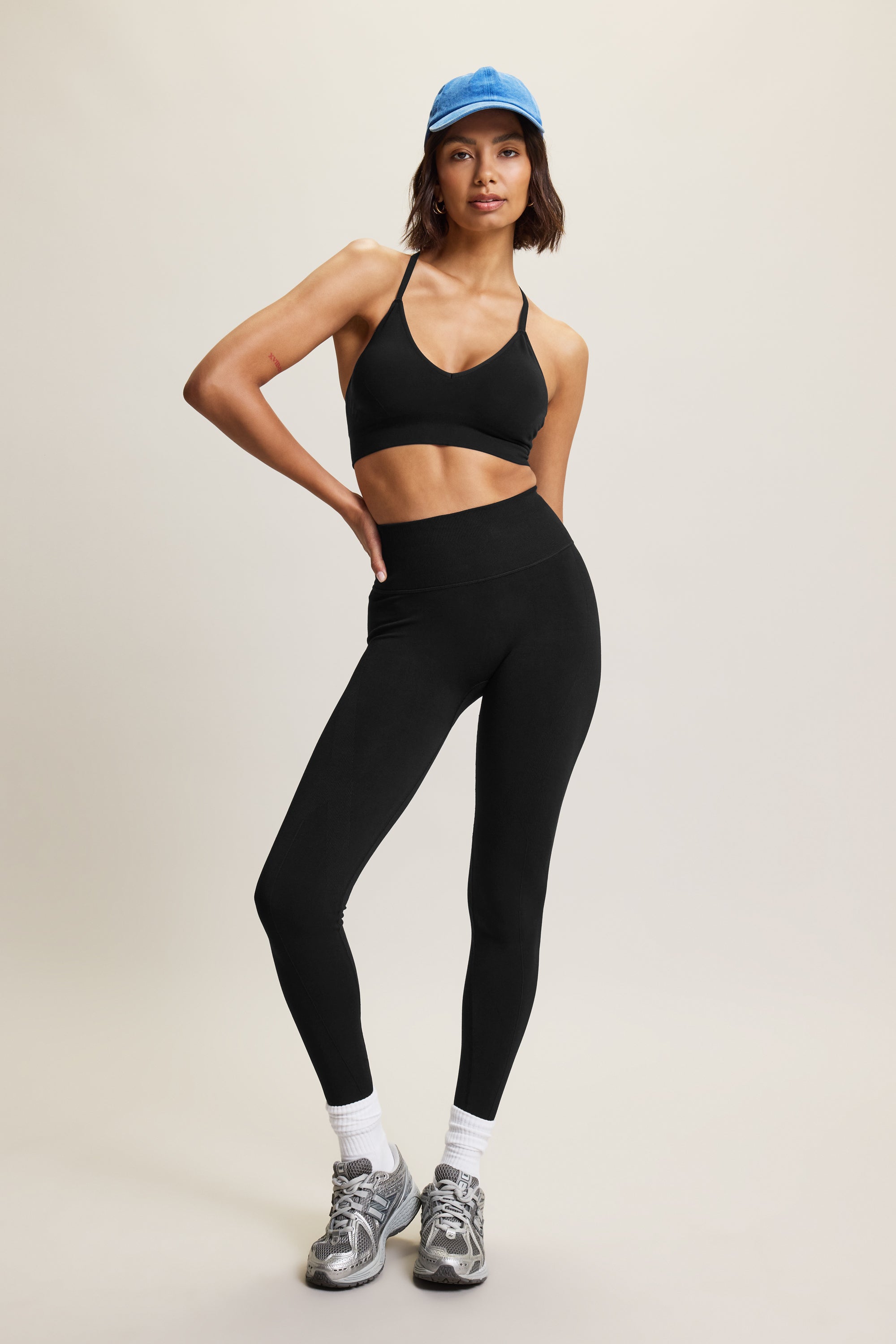 High-waisted black seamless sculpting leggings for women in eco-friendly fabric, perfect for athleisure, activewear, and yoga. Moisture-wicking and squat-proof design ideal for performance, workout, and fitness activities. Fashionable, figure-hugging leggings offering tummy control and breathable comfort, crafted from sustainable materials for versatile all-day wear.