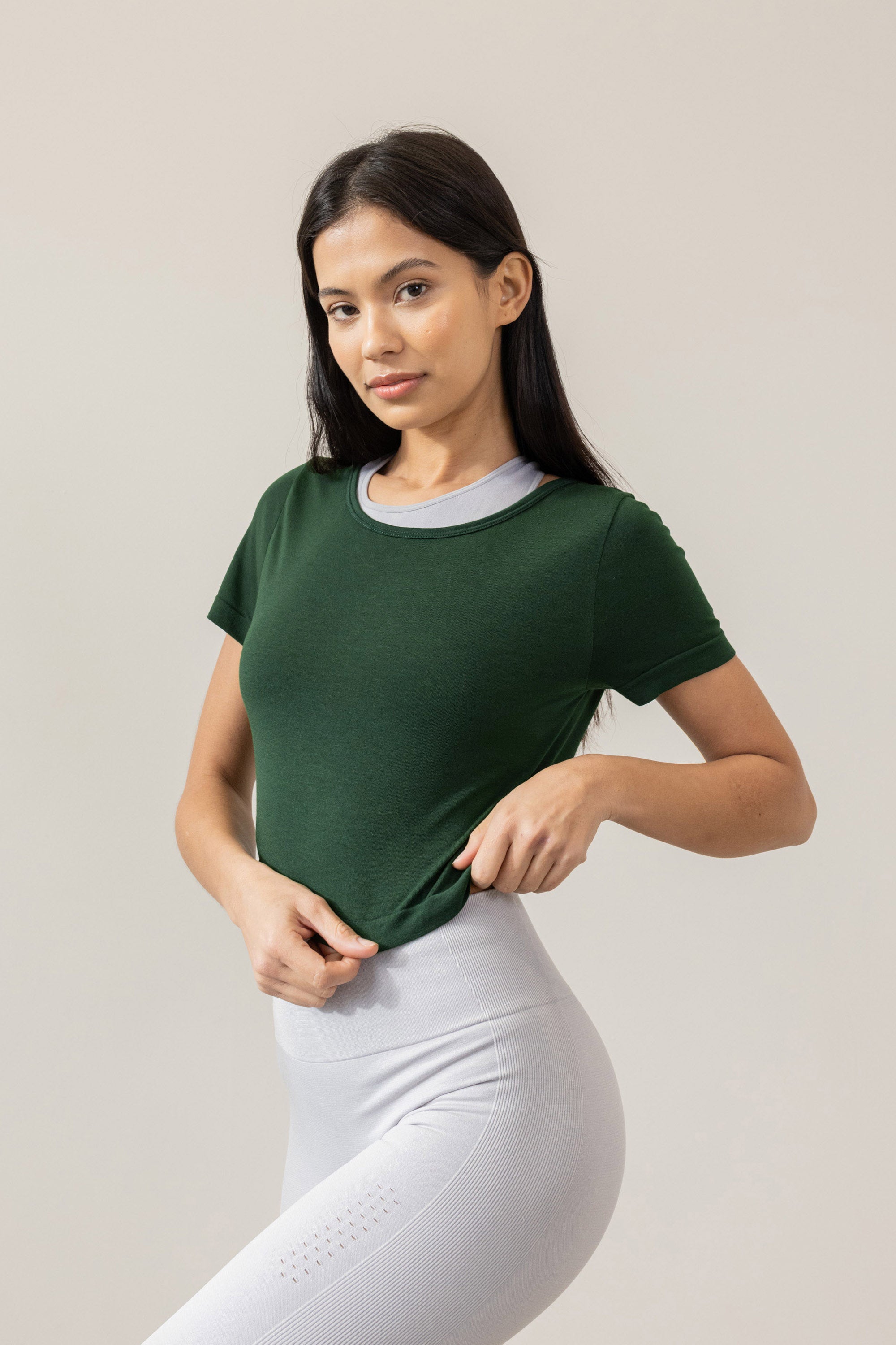 Meet our dark green Frances Modal Tee - your go-to for yoga or any workout! With a cropped length and low back, it's perfect for layering over leggings and a sports bra. Crafted from gentle Lenzing modal fabric blended with recycled polyamide, it offers unmatched softness and comfort. Cut to meet your leggings' waistband, it's a versatile must-have for your activewear collection. Experience comfort and style with Frances Modal Tee by Jilla Active