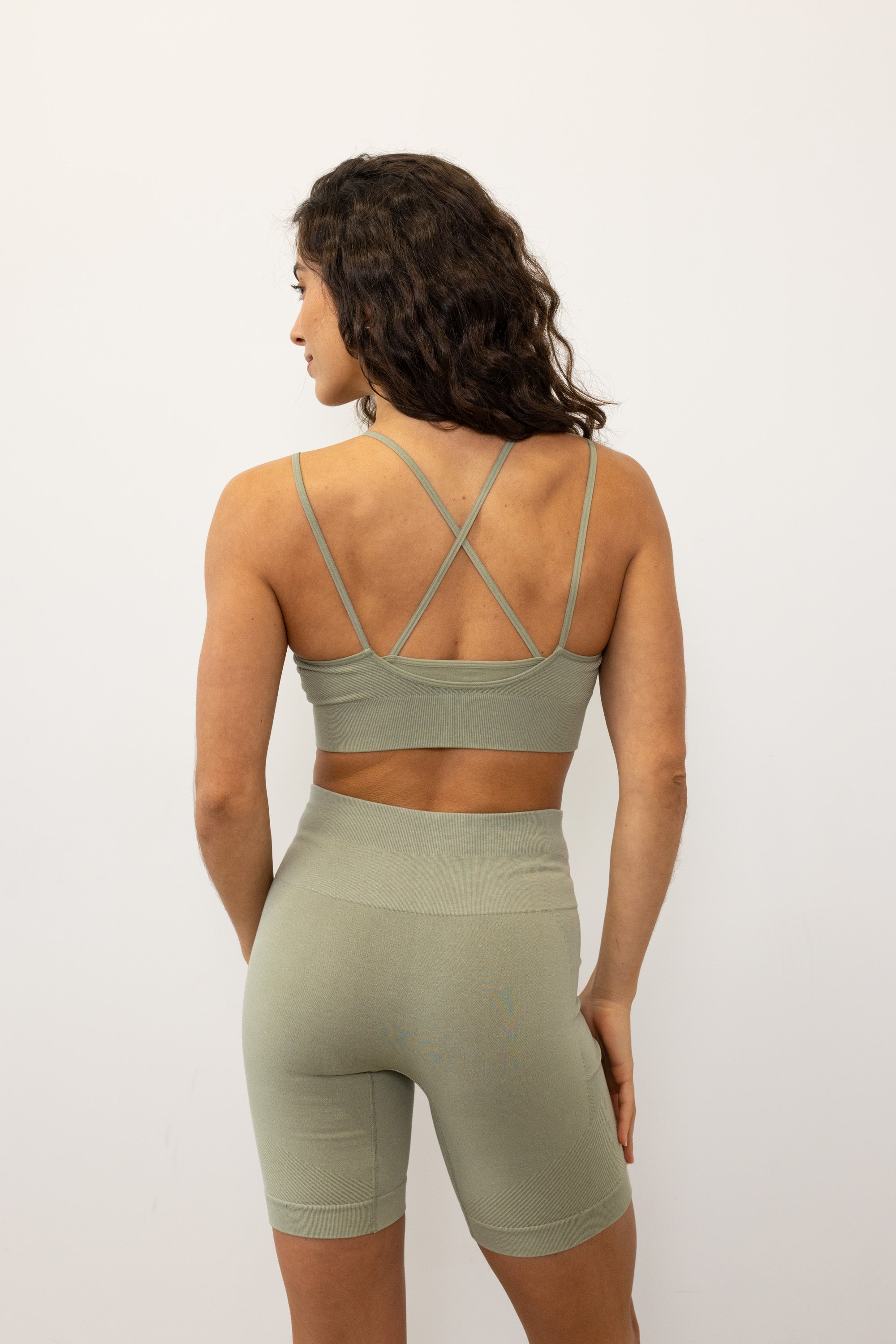Introducing our Mandala Modal Yoga Bra crafted for style and comfort in low impact workouts. With a feminine double layered design, crossover straps, and textured detail, it offers both fashion and function. Seamlessly knitted in soft Lenzing Modal fabric, recycled polyamide, and elastane, it provides flexible support for yoga, pilates, and barre. With light support, triple-layered fabric, and removable pads, it ensures comfort and customization.