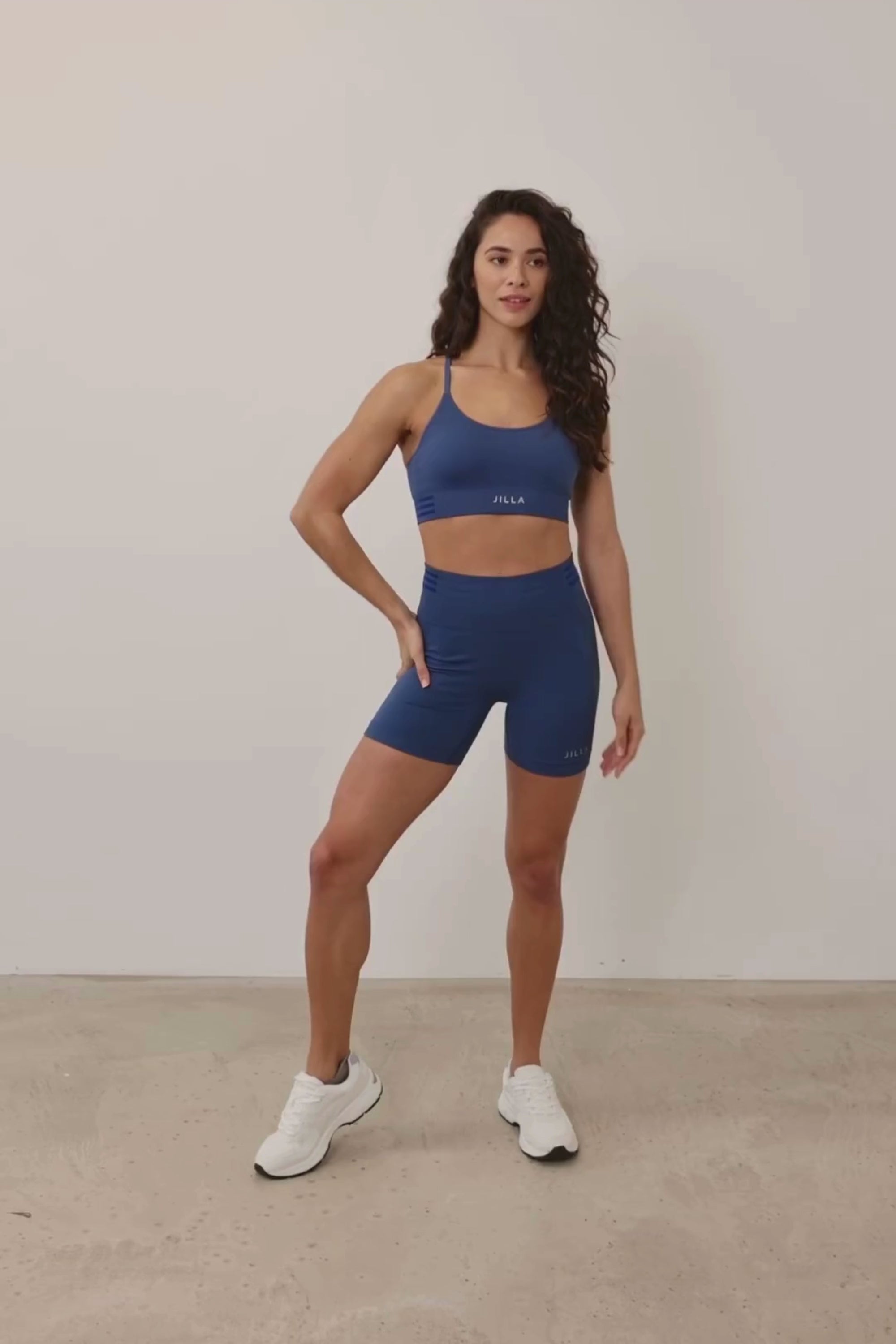 Meet our new denim blue Tone & Lift Recycled Sports Bra! Crafted for comfort and functionality, it's perfect for your active lifestyle. Made with sweat-wicking fabric and adjustable straps, it offers support and adaptability. With stylish details and light to medium support, it's ideal for yoga, pilates, and beyond. Elevate your workout with sustainable style by Jilla Active